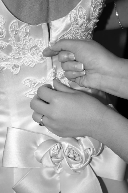 a woman's hands and dress is being sewn