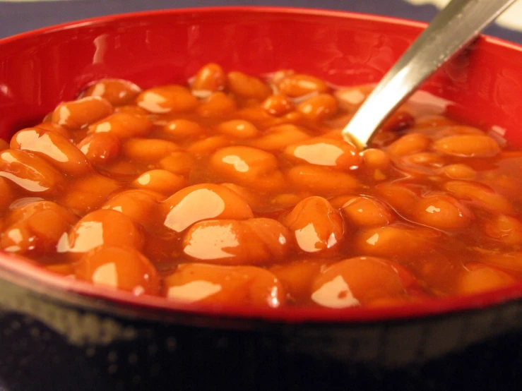 a spoon that is in a red bowl