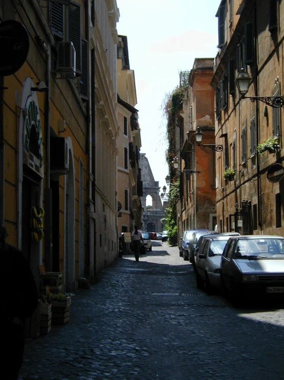 there are cars parked on the street next to some buildings