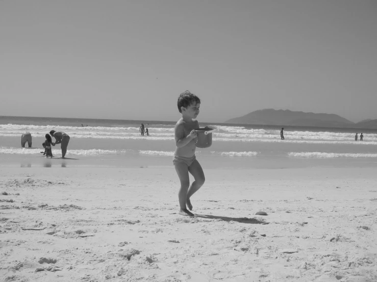 a black and white po of a  running on the beach