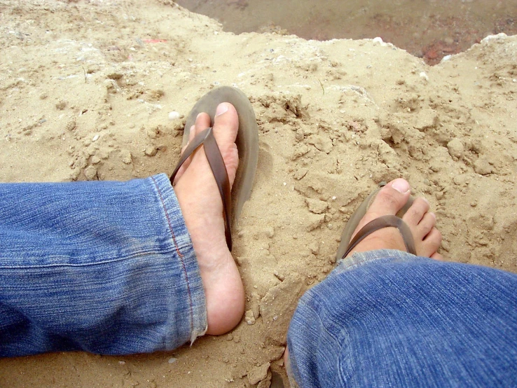 the person is standing in sand on his feet