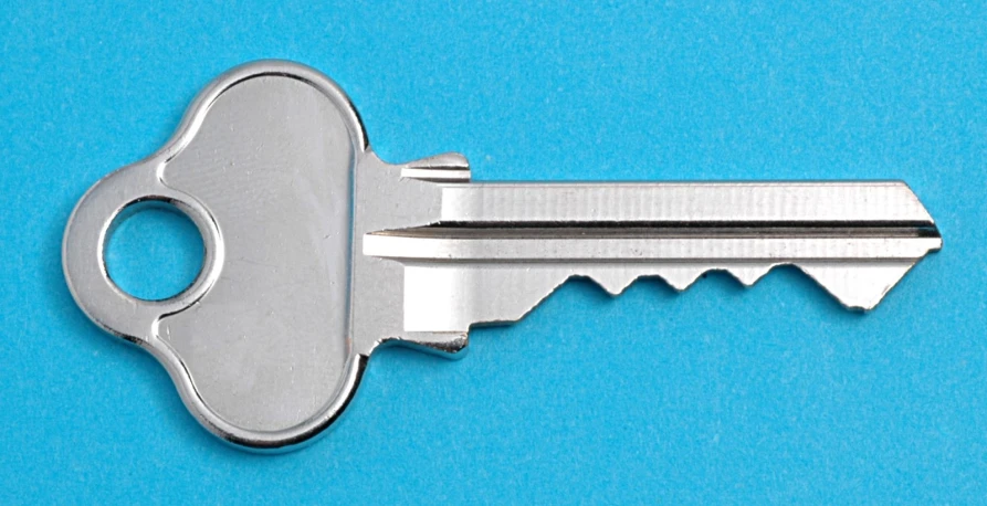 a metal key that is on the side of a blue surface