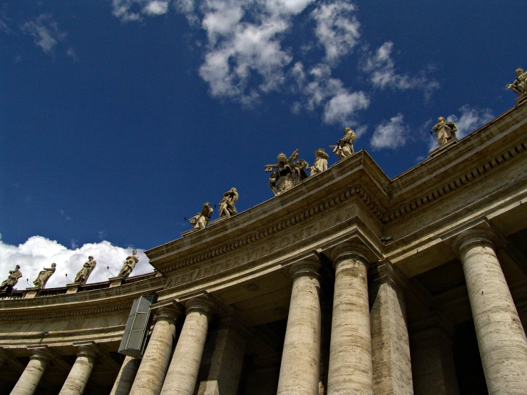 some large pillars and a sky with clouds