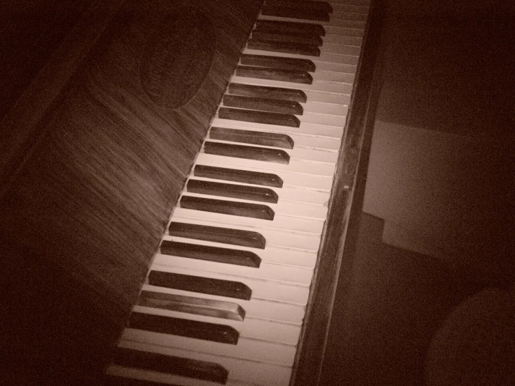 a long, black piano has many keys