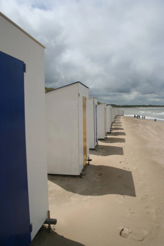 many storage containers sitting outside of a beach side