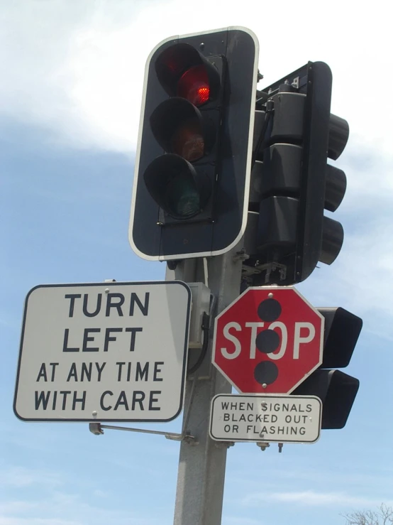 a couple of traffic signals that are next to a stop sign