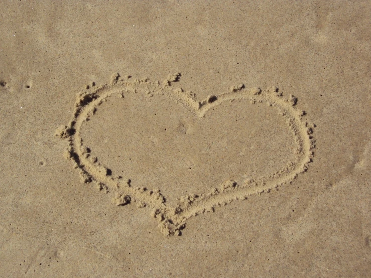 there is a heart shaped on a beach