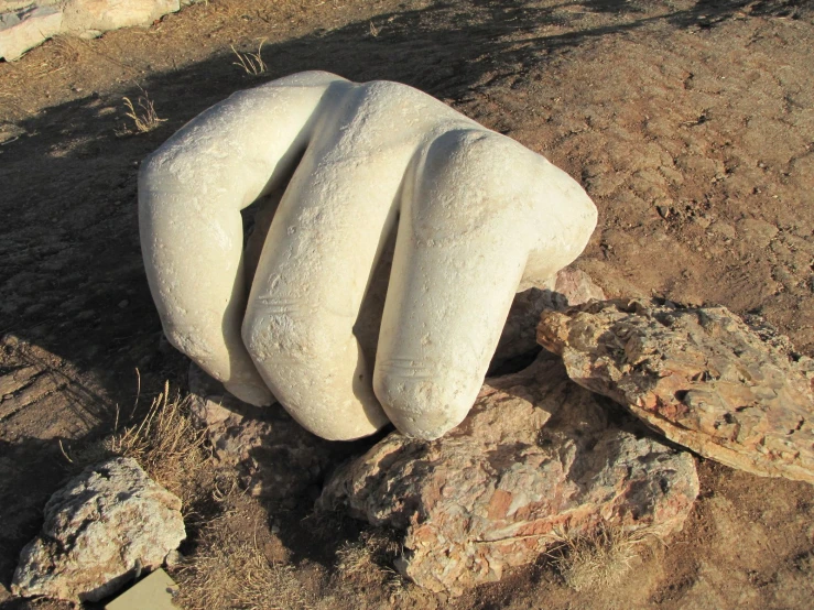 large white boulders lying on rocks in a barren area