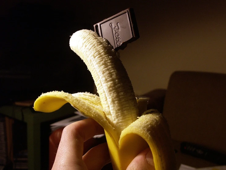 there is a peeled banana sitting in the hand