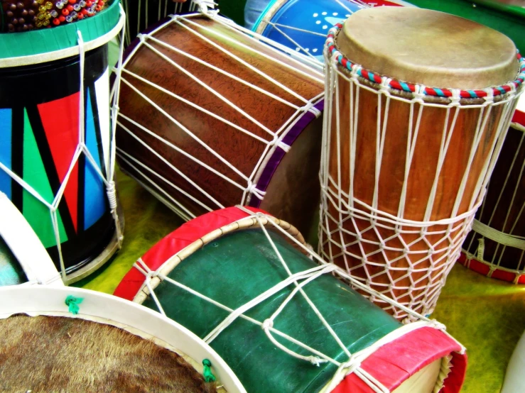 several colorful drums, including african drumming, are lined up