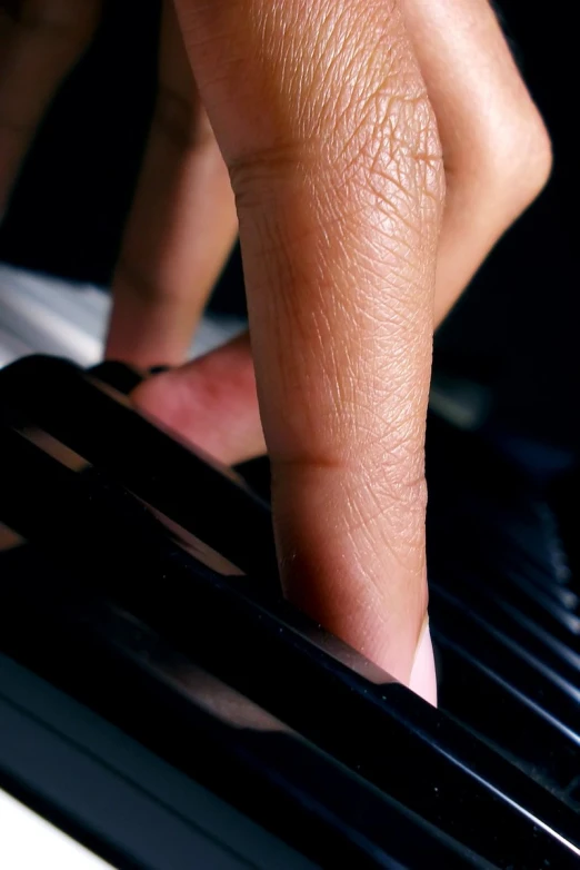 a man is touching the hand of a piano