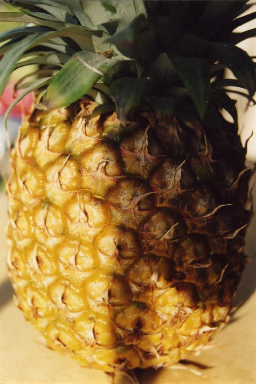 the pineapple is standing on top of the wooden table