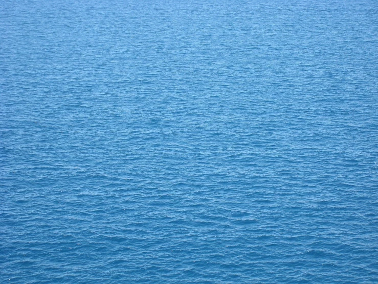 a body of water with small waves and a boat