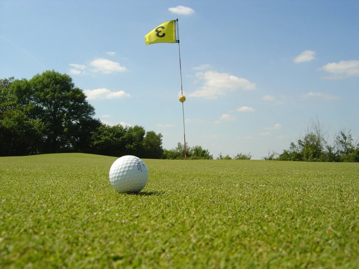 the golf ball and flag are on the tee