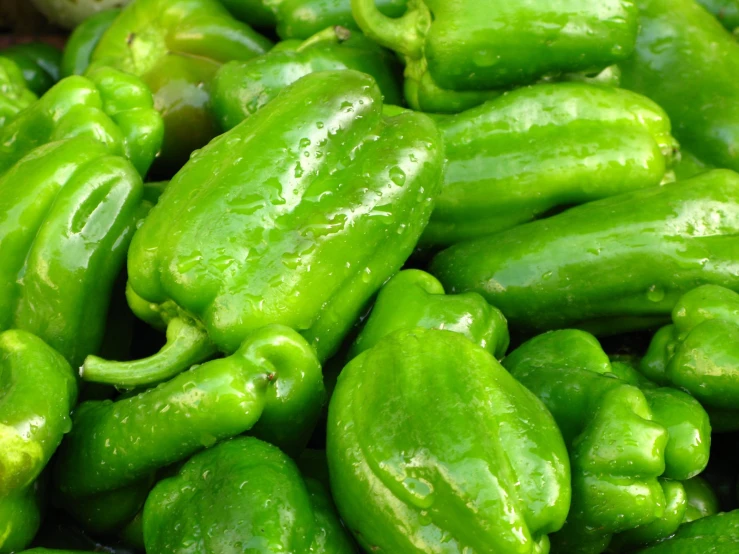 many green peppers piled on each other