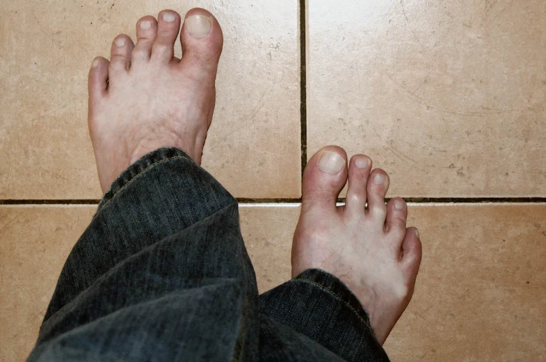 the person is standing in front of some tiles