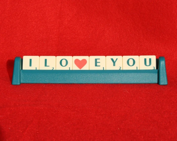 a wooden block set with the words i love you spelled on it