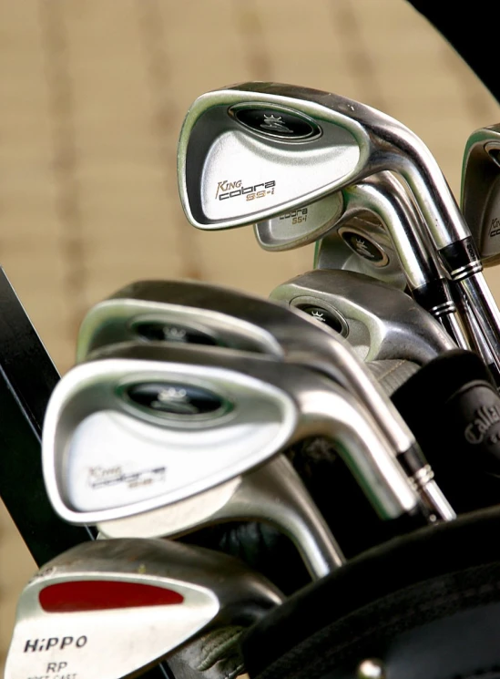 a bunch of golf clubs are in a holder