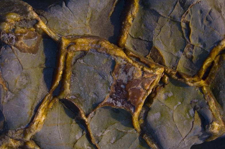 the rock is peeling, with yellow paint on it