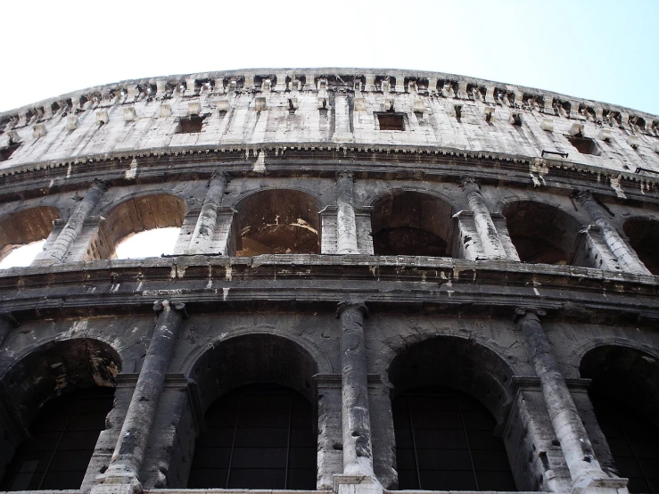 the round building is made of stone and has several doorways