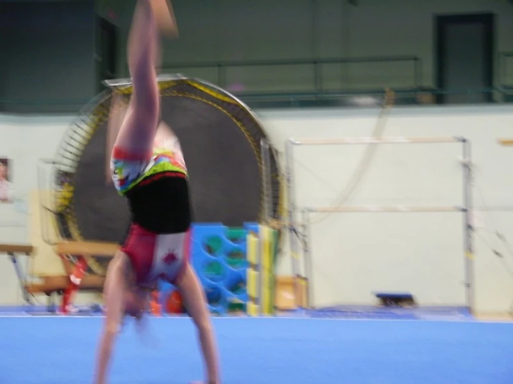 this is an image of a person on a mat doing a handstand