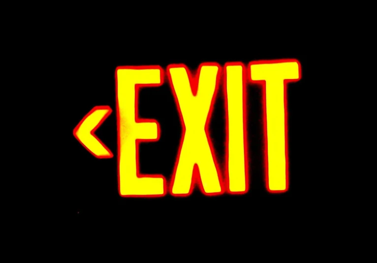 a lit sign that says exit