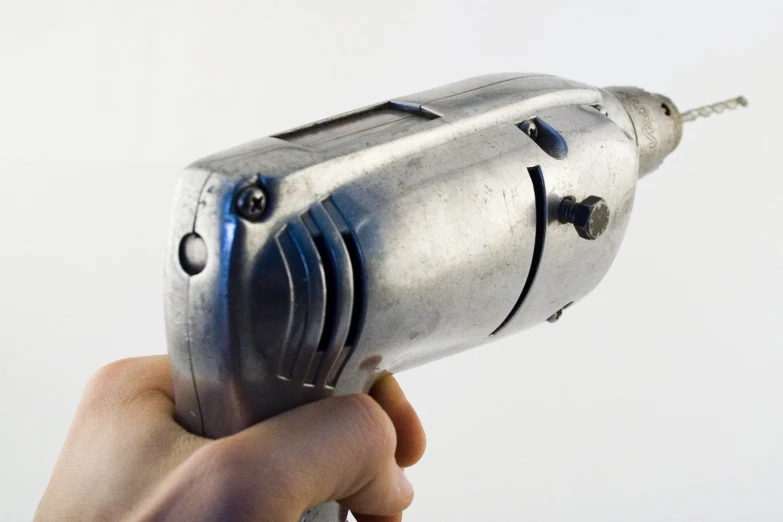 a close - up image of a person's hand holding a hair dryer