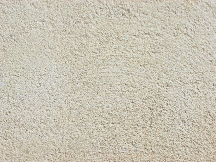 an abstract textured stucco wall with a small white dot
