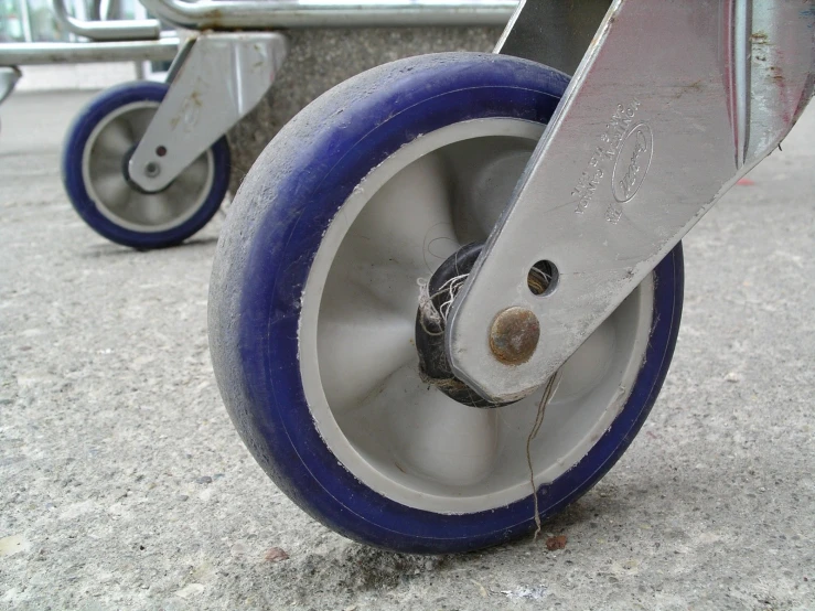 a metal wheel on an old metal cart