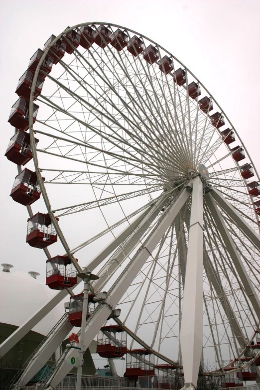 a ferris wheel sitting in front of a cloudy sky