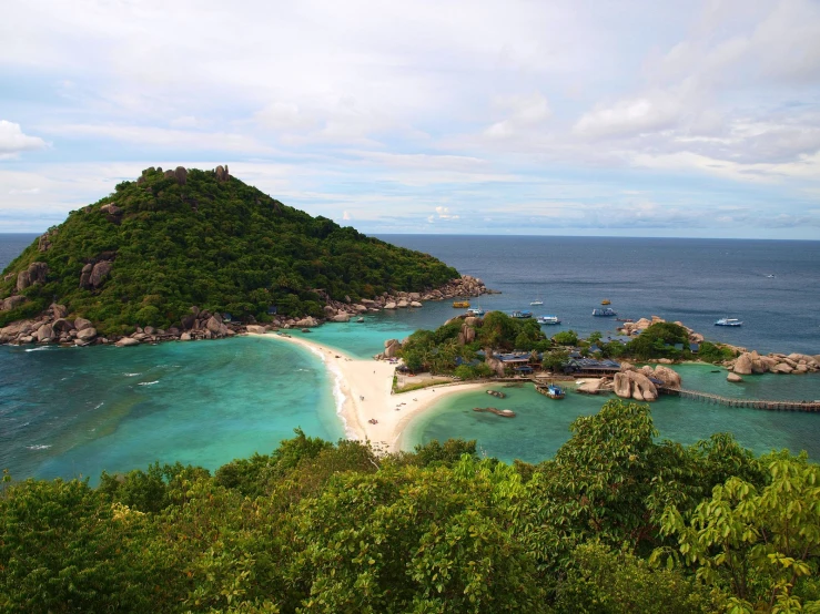 a small island off the coast with several small boats