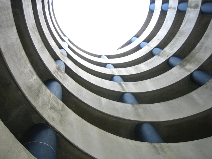 the spirally entrance to the building has blue poles