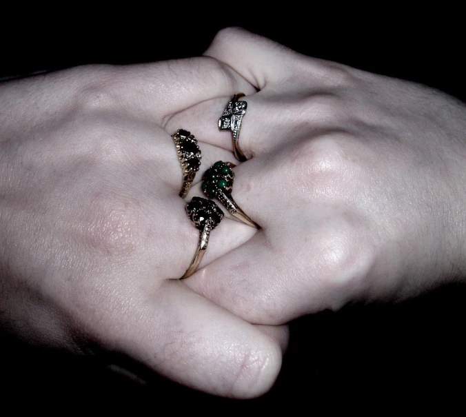 three diamond ring sets in the palm of someone's hand