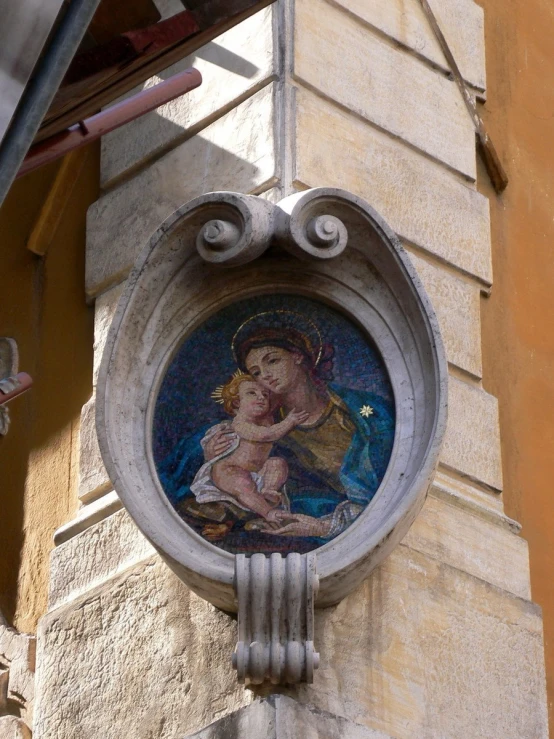 a clock on the side of a building that displays a virgin mary