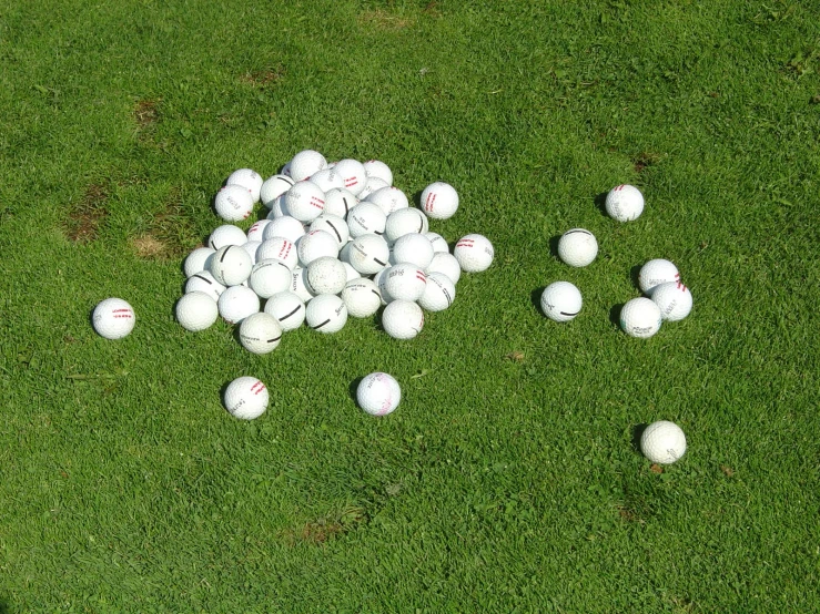 a number of balls scattered on the grass