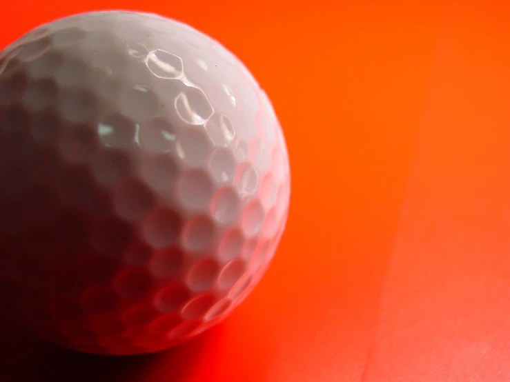 a ball is sitting on a red table