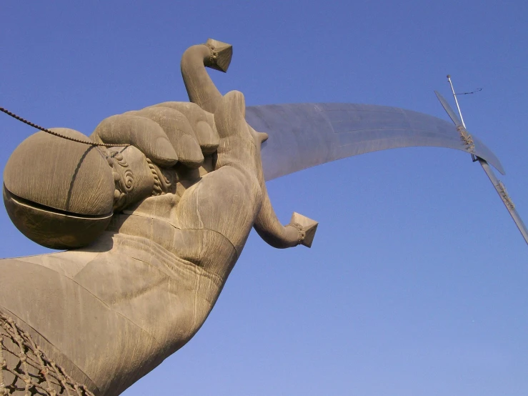 the sculpture is near a blue sky