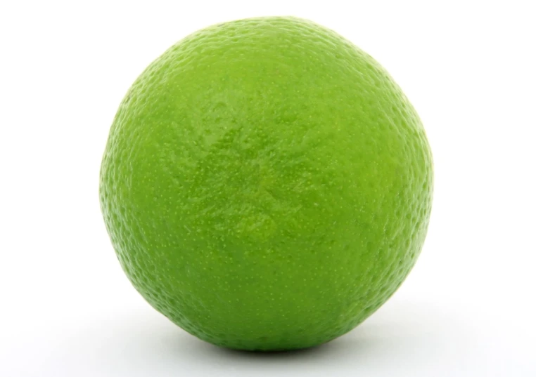green citrus fruit on white background, in the foreground
