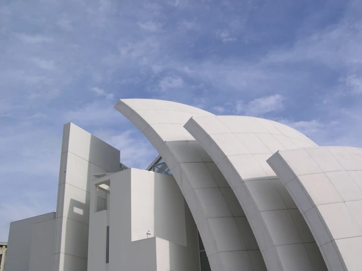 a building with lots of curves in the center and the sky above it