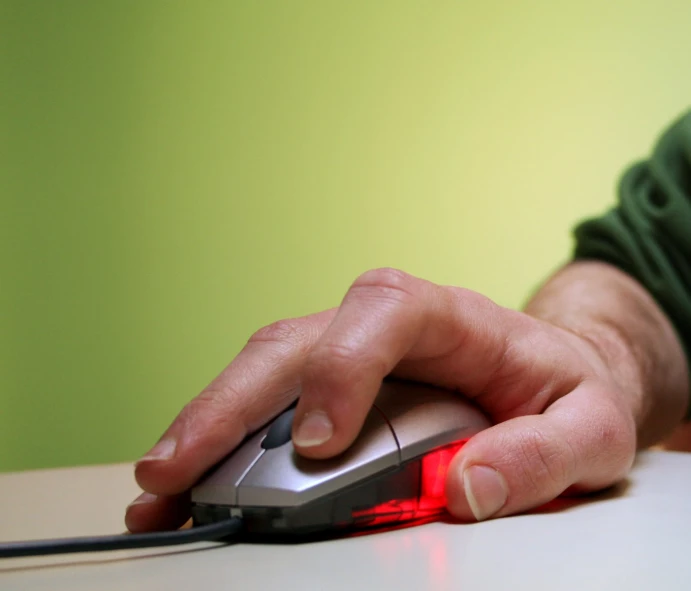 a person is sitting down using a computer mouse