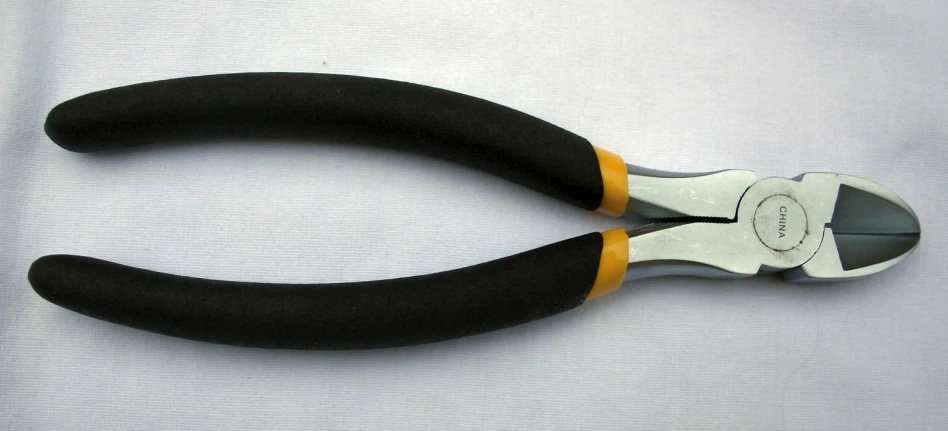 an opened pair of scissors with black handles and yellow tips