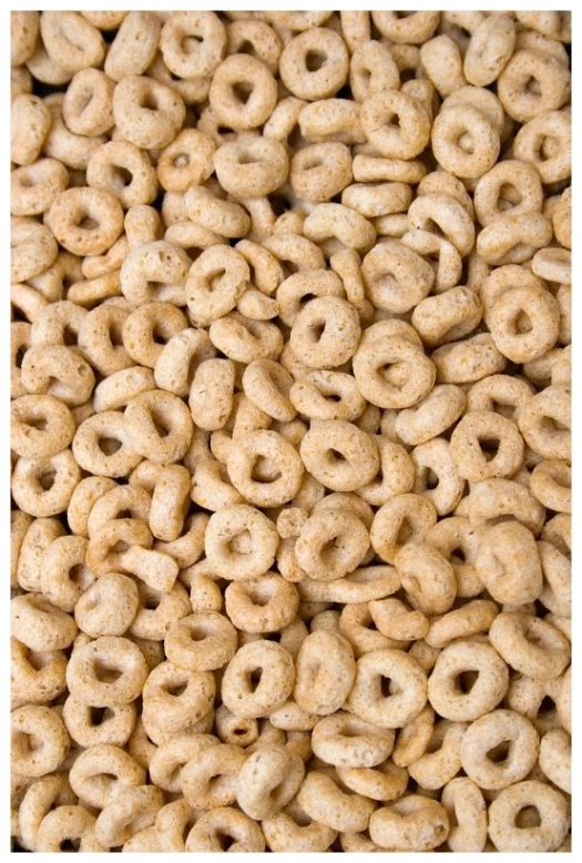 a close up image of lots of cereal with little pieces of food in the middle