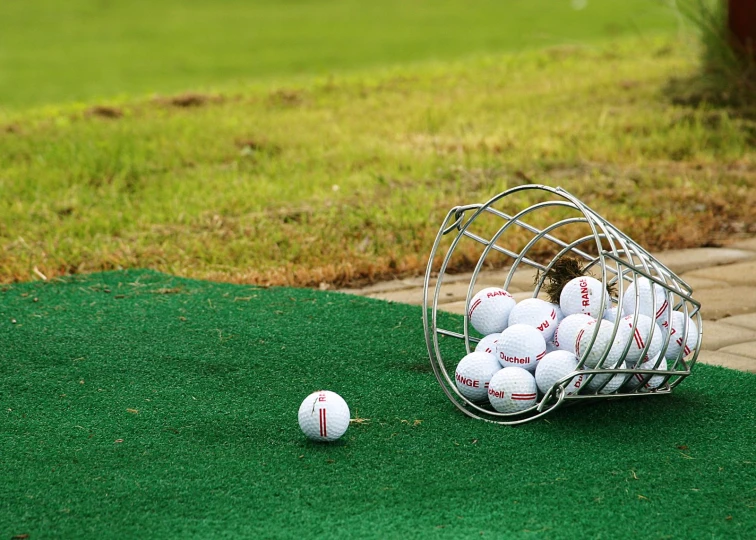 many golf balls are inside a wire basket