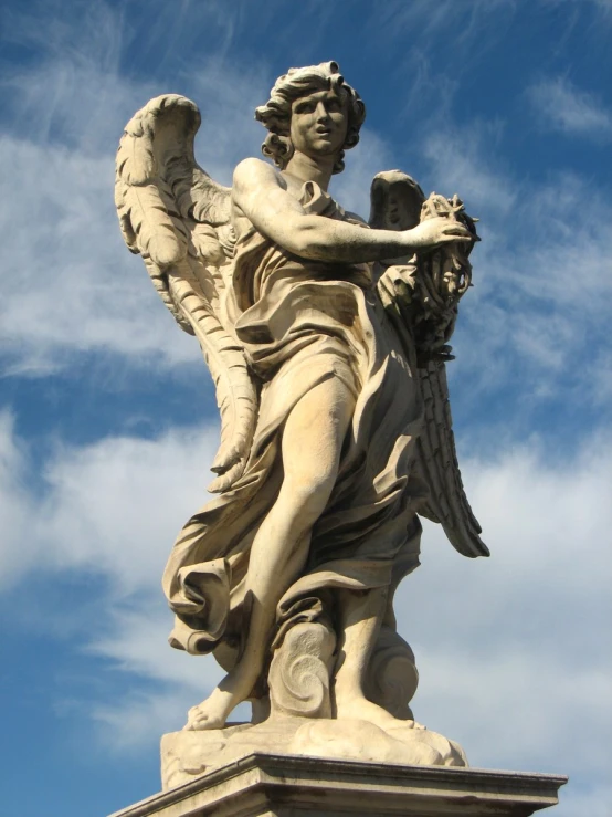 an angel statue stands with its wings outstretched