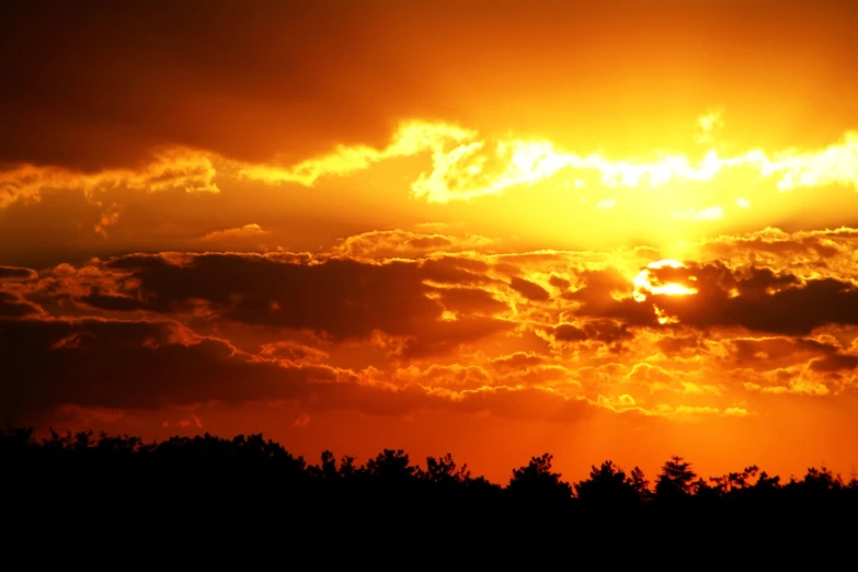 a sunset with the sun reflecting in water