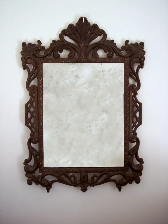 a wall mounted mirror mounted to the side of a wall