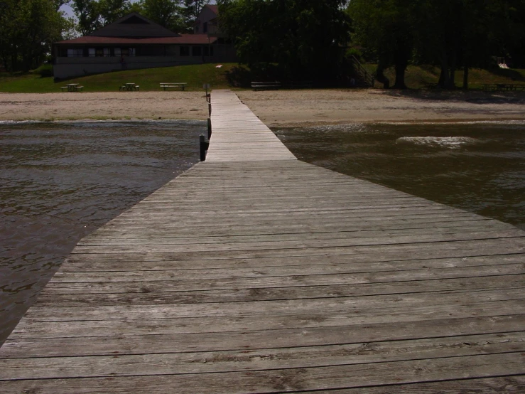 a wooden walkway over the water leading to a small dock