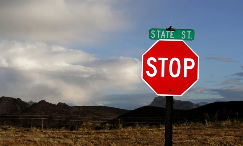 there are two street signs that is on a stop sign