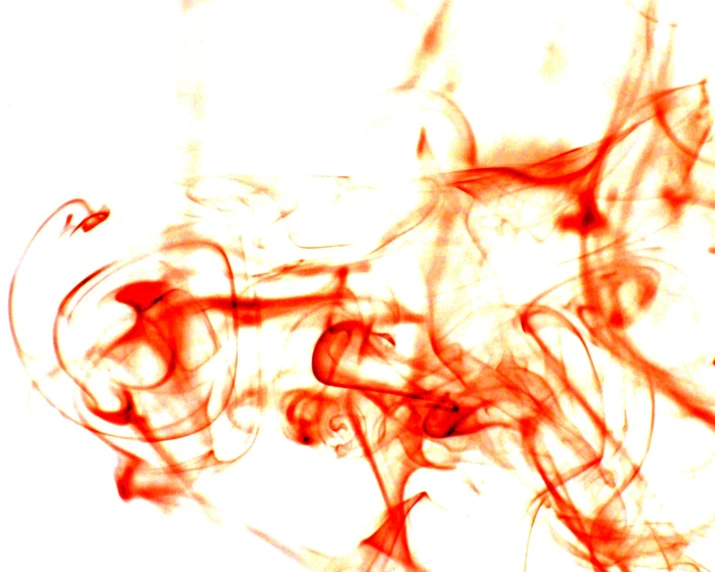 abstract pograph of red ink swirling on the surface