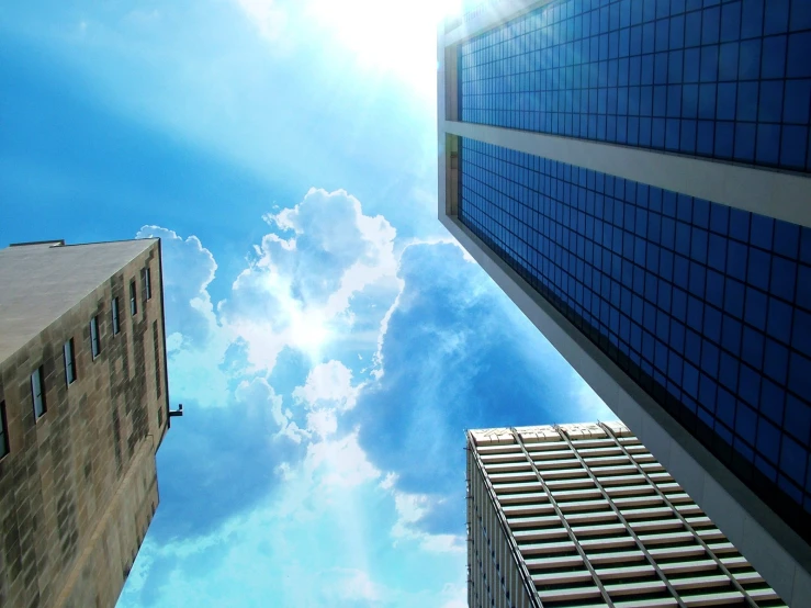 the tops of two buildings that look toward the sun